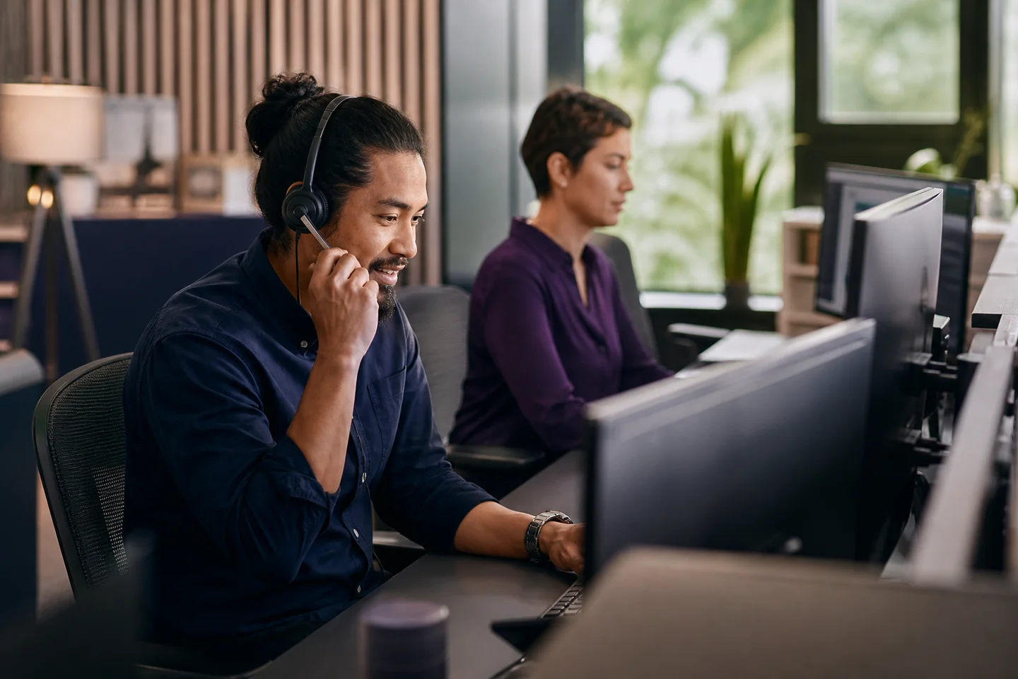 Customer operations professionals coordinating calls and digital conversations together